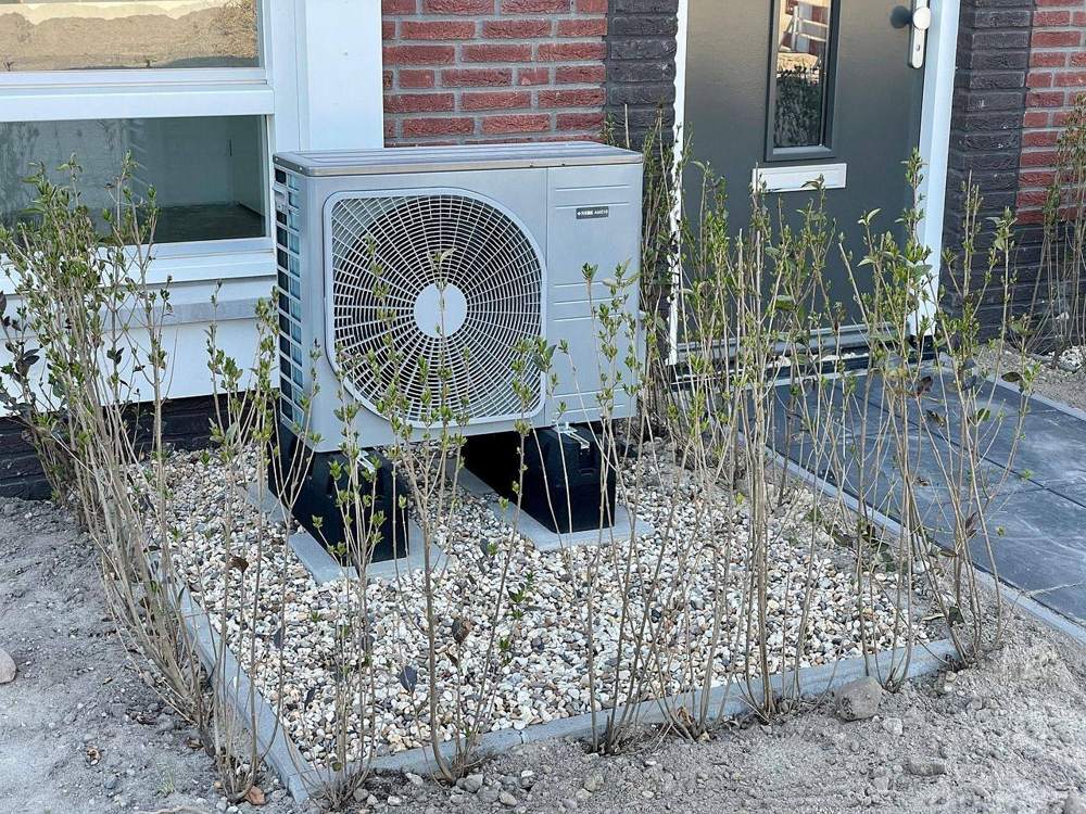 Heat pump outside a brick house
